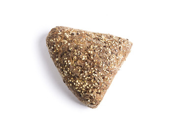 Triangle-shaped wholemeal bread with linseed, oats and sesame seeds on a white background
