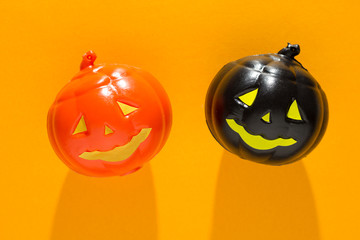 Halloween background concept. Top view of jack O pumpkin faces on orange table