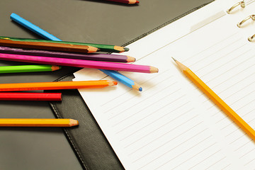 Fototapeta premium The notebooks and colored pencils. Business concept