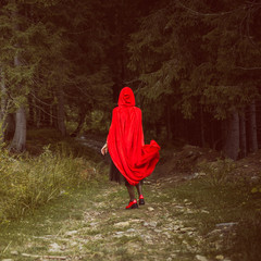  Concept of Halloween. Beautiful and simple costume of little red hood. Mysterious hooded figure in...