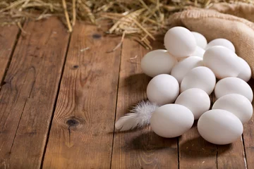 Fototapeten white eggs on wooden table © Nitr