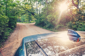 View from SUV sunroof top, driving down a country dirt, road