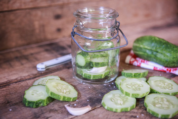 Sliced cucumbers fresh from the garden and ingredients to make refrigerator pickles