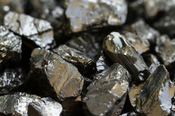 Black coal mine close-up with soft focus. Anthracite coal bar on dark background