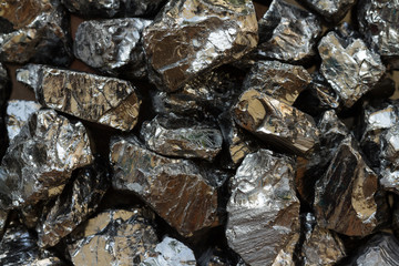 Natural black coal bars for background. Industrial coal nuggets close up