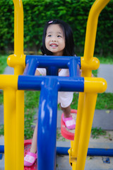 Fototapeta na wymiar Happy little girl exercise in the park