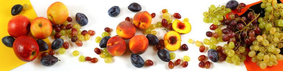 Panorama with apples, peaches, plums and grapes