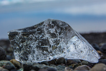 Close up of block of ice on pebbles