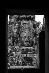 Faces of Bayon temple in Angkor Thom, The Bayon's most distinctive feature is the multitude of serene and smiling stone faces on the many towers