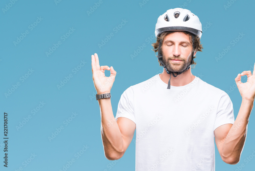 Sticker Handsome hispanic cyclist man wearing safety helmet over isolated background relax and smiling with eyes closed doing meditation gesture with fingers. Yoga concept.