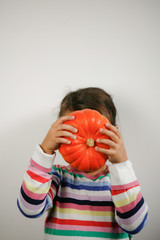 Child holding Squash in front of Face