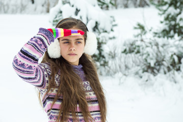 Fototapeta na wymiar happy winter girl in bright warm clothes. Christmas in a winter park. girl in winter. Portrait of young beautiful girl Outdoor. 