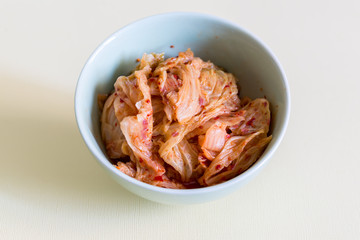 Cabbage kimchi in the bowl, very popular korean traditional fermented food.