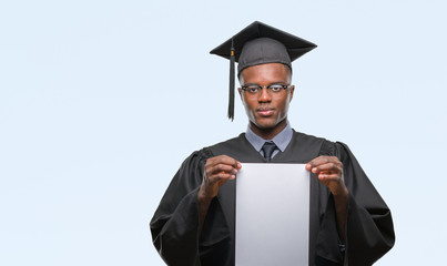 Young graduated african american man holding blank paper degree over isolated background with a confident expression on smart face thinking serious