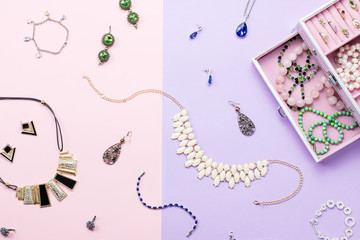 Open jewelry box with neclaces, earrings and rings on pastel background. Top view