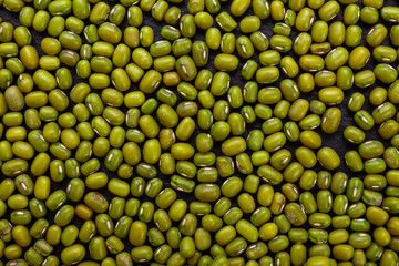 fresh Mung beans on a dark stone background