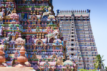 Gopurams in Sri Ranganathaswamy Temple, India. A Gopuram is a monumental gatehouse tower, usually ornate, at the entrance of a Hindu temple usually found in the southern India
