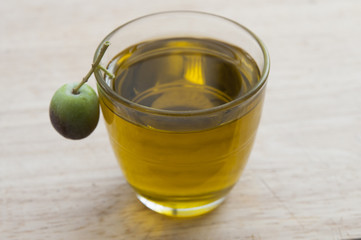 olive oil in a glass and olives