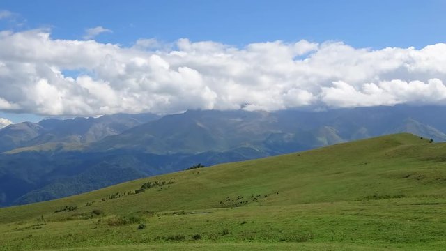 Time lapse mountains scenes in national park Dombai, Caucasus, Russia, Europe. Summer landscape, sunshine weather, blue sky and sunny day. 4K footage, video camera format 3840x2160