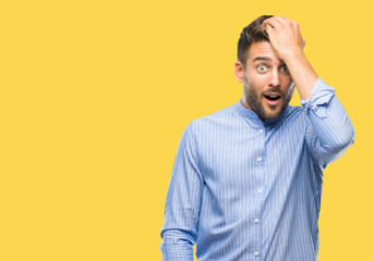Young handsome man over isolated background surprised with hand on head for mistake, remember...