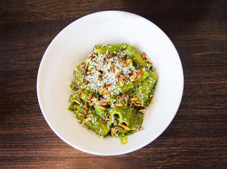 Pesto pasta on a plate top view
