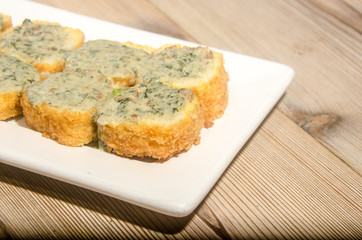 Weathered sushi roll with rockefeller sauce