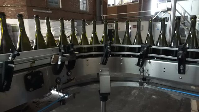 Bottling and sealing conveyor line at winery factory