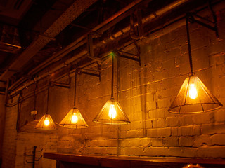 Vintage lighting lamp hang in front of cement brick wall at loft.
