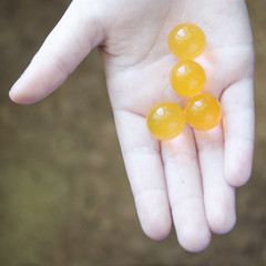 four big balls of orange arbis on the child's hand
