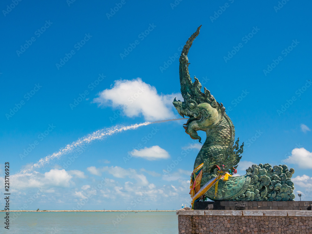 Wall mural Naga statue spray with blue sky 