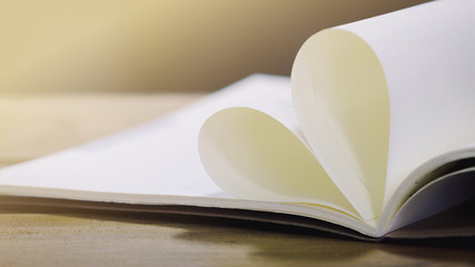 Heart shape paper book on wood table