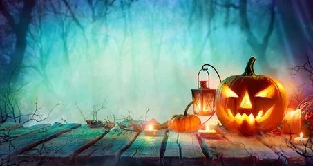 Fototapeten Halloween - Jack O' Lanterns And Candles On Table In Misty Night   © Romolo Tavani