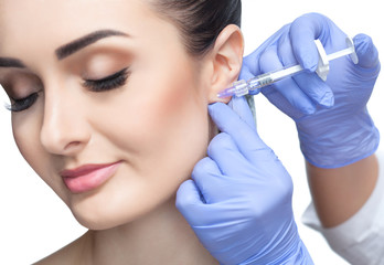 The doctor cosmetologist makes the Rejuvenating facial injections procedure for smoothing wrinkles...