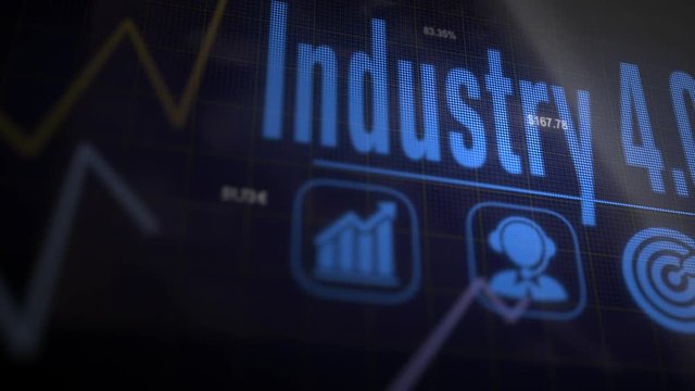A Industry 4.0 business concept on a flashing computer monitor with moving graphs and data.