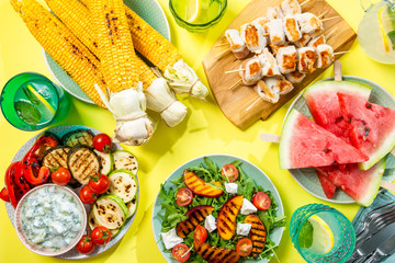 Summer bbq party concept - grilled chicken, vegetables, corn, salad, top view, copy space © anaumenko