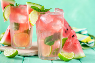 Watermelon lemonade with lime and mint, wood background, copy space