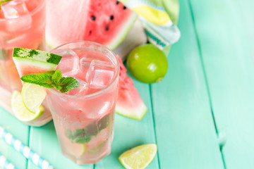 Watermelon lemonade with lime and mint, wood background, copy space