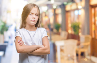 Young beautiful girl over isolated background skeptic and nervous, disapproving expression on face with crossed arms. Negative person.