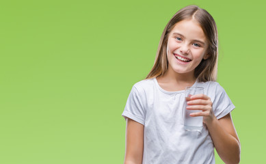 Young beautiful girl drinking glass of water over isolated background with a happy face standing...