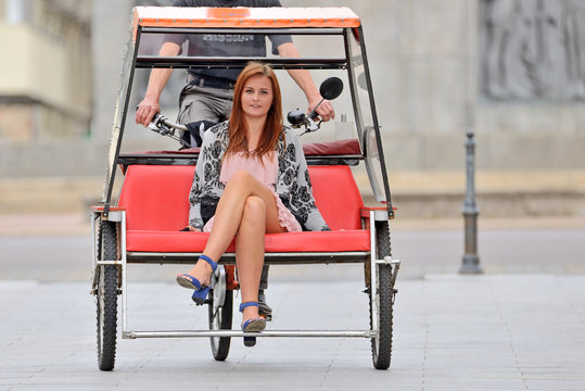 Fototapeta Girl riding a rickshaw - ul. Piotrkowska, Łódź, Poland
