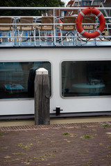 Cruising ship in the Leiden harbor with the orange lifebuoy
