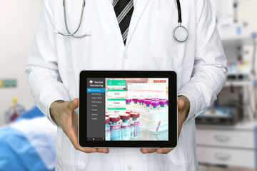 Professional doctor using application of tablet to remote monitor vaccines or blood temp sensors in sensitive medical Refrigerators. Smart iot technology , wireless temperature monitoring concept. - Powered by Adobe