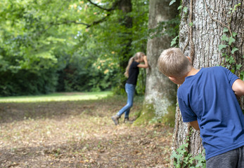 Kids playing hide and seek in the forrest 