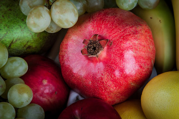 pomegranates and other fruit in the basket