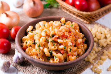 Pasta with tomato sauce on a plate on table