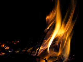 Burning hearth in the evening in the dark.