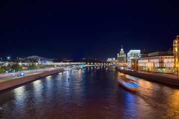 Naklejka premium Stalin Skyscraper on Kotelnicheskaya Embankment of the Moscow River. Night shot of Moscow river reflection. Panorama view of Moscow city, Russia