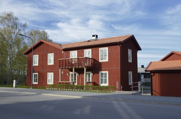 Scandinavian housing, classic red villa with blue sky