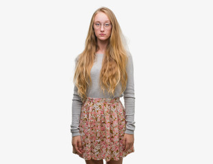 Blonde teenager woman wearing flowers skirt depressed and worry for distress, crying angry and afraid. Sad expression.