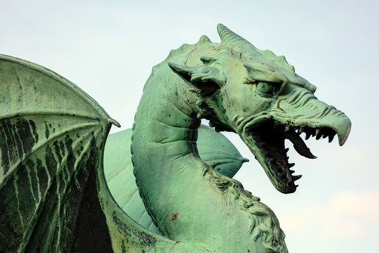 Dragon statue on the Dragon Bridge in Ljubljana, Slovenia. The bridge, decorated with the Dragon statues at four corners, was built in 1901 and since then has become a symbol of the city.